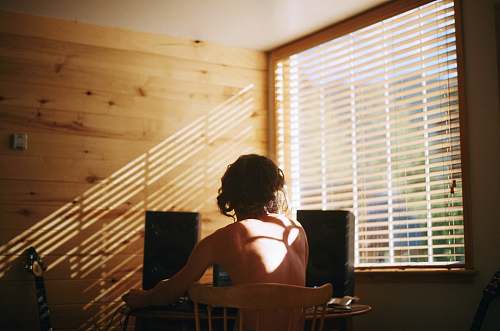 human woman sitting on brown chair person